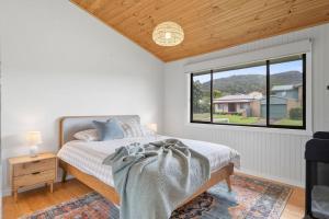 Ένα ή περισσότερα κρεβάτια σε δωμάτιο στο Shell Shack - BYO Linen