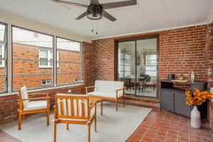 a living room with chairs and a ceiling fan at Elegant Spacious Retreat Perfect For Families in Wilmington