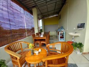 a dining room with a wooden table and chairs at Stella Dell Mare Homestay and Tour in Labuan Bajo