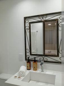 a bathroom with a sink and a mirror at Hotel Internacional Plaza Paulista in Sao Paulo