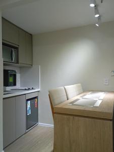a kitchen with a table and a counter top at Hotel Internacional Plaza Paulista in Sao Paulo