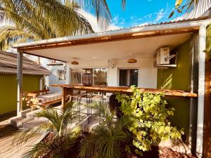 a house with a patio with a table and plants at Cocon Romantique in La Saline les Bains