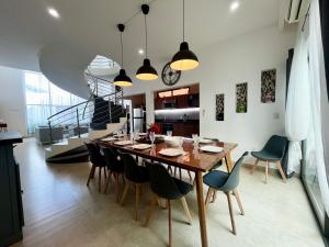 a dining room with a wooden table and chairs at Spectacular Private House in Playa del Carmen