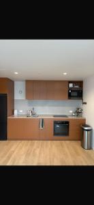 a kitchen with brown cabinets and a sink and a stove at South Melbourne retreat in Melbourne
