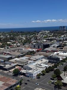 an aerial view of a city with the ocean at South Melbourne retreat in Melbourne