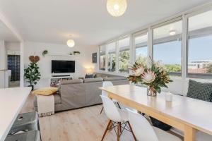 een woonkamer met een tafel en een bank bij Aldinga Beach Breakaway - C21 SouthCoast Holidays in Aldinga Beach