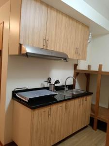 a kitchen with a sink and a stove at Luntian Luxury Condo in Tagaytay in Iruhin