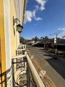 a balcony of a building next to a street at Imperial Cidade Smart Suítes in Ouro Preto
