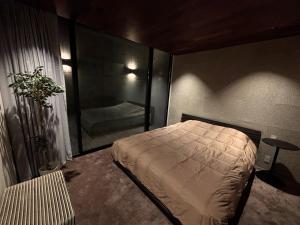 Ένα ή περισσότερα κρεβάτια σε δωμάτιο στο Shimokita Villa , 下北ヴィラ