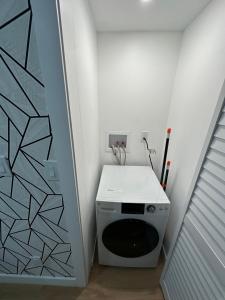 a laundry room with a washing machine in a room at The View - Direct Bus Time Square NYC Breakfast Included - C in Jersey City