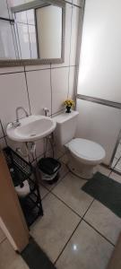 a bathroom with a white toilet and a sink at Fique a vontade in Uberaba +11 photos
