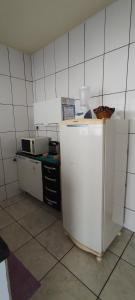 a kitchen with a white refrigerator and a microwave at Fique a vontade in Uberaba