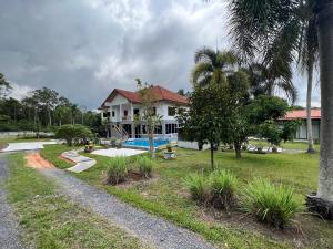 a house with a swimming pool in a yard at Theorenda house in Ban Taling Ngam