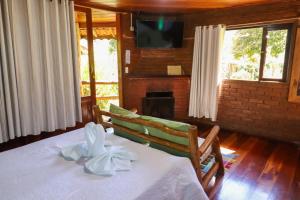 Voodi või voodid majutusasutuse Pousada Das Araucárias toas