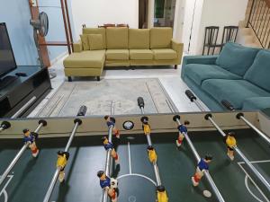 a view of a living room with people playing ping pong at Warisan Indah Homestay KLIA 2 Melayu sahaja in Sepang