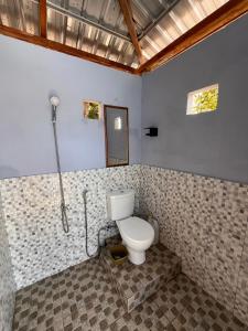 a bathroom with a toilet in a room at Modo homestay komodo village in Komodo +85 photos