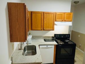 a small kitchen with a sink and a stove at Northside-Private Bath #5 Shared # 3 in Atlanta