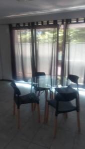 a dining room with a glass table and chairs at Villa Lastenia 2 in San Salvador de Jujuy