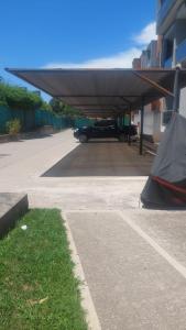 a parking lot with a tent under a building at Villa Lastenia 2 in San Salvador de Jujuy