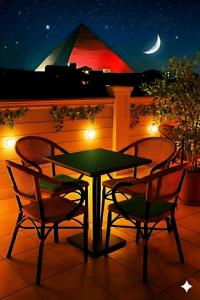 a table and chairs on a patio at night at Pyramids & SphinX Grand Hotel in Cairo
