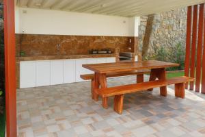 a picnic table and two benches on a patio at J's PALM BEACH Resort in Batangas City