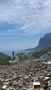 a large city with buildings and mountains in the background at Casa da Angela Quarto Triplo in Rio de Janeiro
