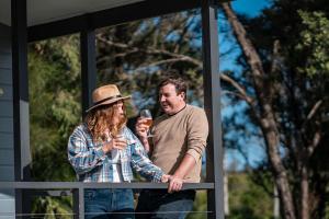 a man and a woman standing in a window at Barlings Beach Holiday Park in Tomakin +39 photos