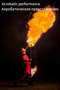 a man holding a pole with fire on it at Horizon Resort & Spa Yalong Bay-Yalong Bay Central in Sanya
