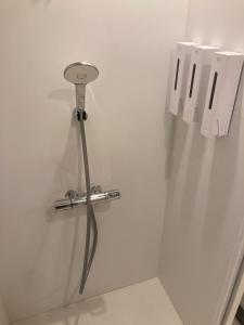 a white wall with a metal object on the wall at STAY local 石蔵 in Numazu