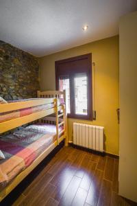 A bed or beds in a room at Apartaments Cal Xic