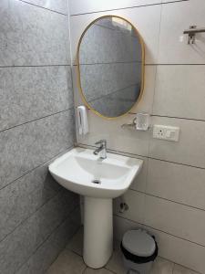 a bathroom with a sink and a mirror at Guest Stay Inn 1BHK in Zirakpur
