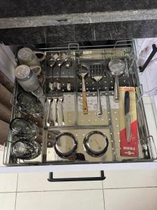 a drawer filled with utensils on top of a counter at Guest Stay Inn 1BHK in Zirakpur