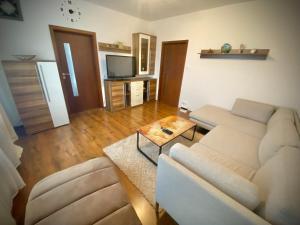 a living room with a couch and a table at 3 izbový byt KNM in Kysucké Nové Mesto +12 photos