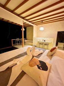 sypialnia z 2 łabędzami na łóżku w obiekcie Cabaña El Mamoncillo - Jacuzzi Privado con Calefacción y Malla Catamarán - Cerca a Medellín w mieście Sopetrán