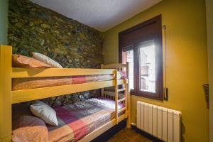 A bed or beds in a room at Apartaments Cal Xic