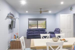a living room with a blue couch and a table at Hichinbrook Lodge, waterfront in Cardwell