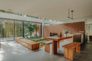 a kitchen with a table and a couch at Moon Rock Villas Ubud by Ribas in Gianyar