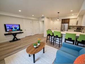 a living room with a blue couch and a table at Boutique KTown Stays With Breathtaking Rooftop Views in Los Angeles