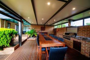 an outdoor dining area with a wooden table and chairs at Waterfront Haven in Yarrawonga