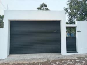 a large garage door with a black door at Biyagama Highway view Luxury House in Kelaniya