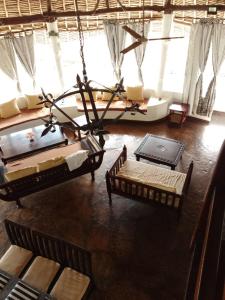 a living room with a chandelier hanging from the ceiling at Artistic Dreamsace 4Br Villa Near Diani Beach in Kwale