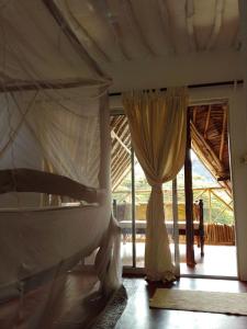 a bedroom with a bed with a canopy and a window at Artistic Dreamsace 4Br Villa Near Diani Beach in Kwale