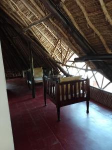 a room with two beds and a thatched roof at Artistic Dreamsace 4Br Villa Near Diani Beach in Kwale +28 photos