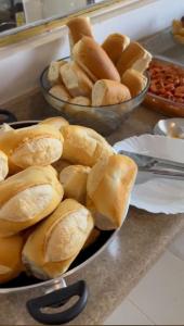 two bowls of buns sitting on a counter top at Hotel MarVinhal in Santa Maria
