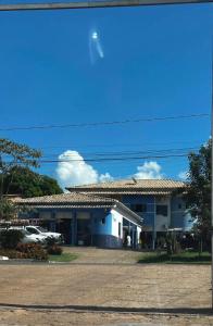 a building with a parking lot in front of it at Hotel MarVinhal in Santa Maria