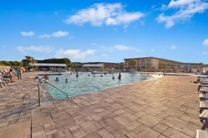 a large swimming pool with people in the water at A145 HH Beach & Tennis Resort in Hilton Head Island