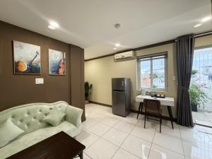 a living room with a couch and a table at La Casona Retreat in Ho Chi Minh City