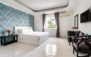 a bedroom with a bed and a table and chairs at La Casona Retreat in Ho Chi Minh City