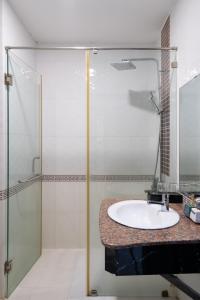 a bathroom with a sink and a shower at La Casona Retreat in Ho Chi Minh City