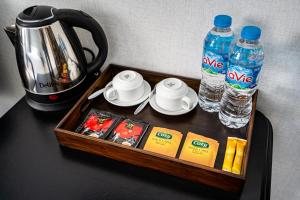 a tray with two bottles of water and a tea kettle at La Casona Retreat in Ho Chi Minh City +18 photos